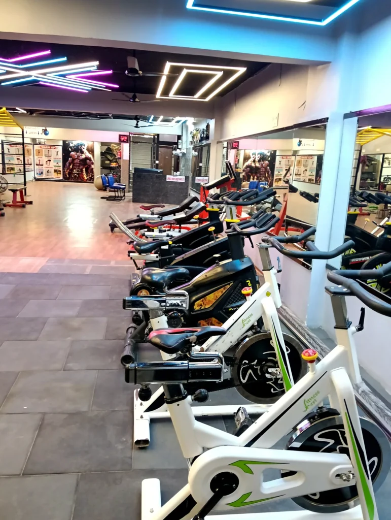Row of stationary exercise bikes at Arya Fitness gym