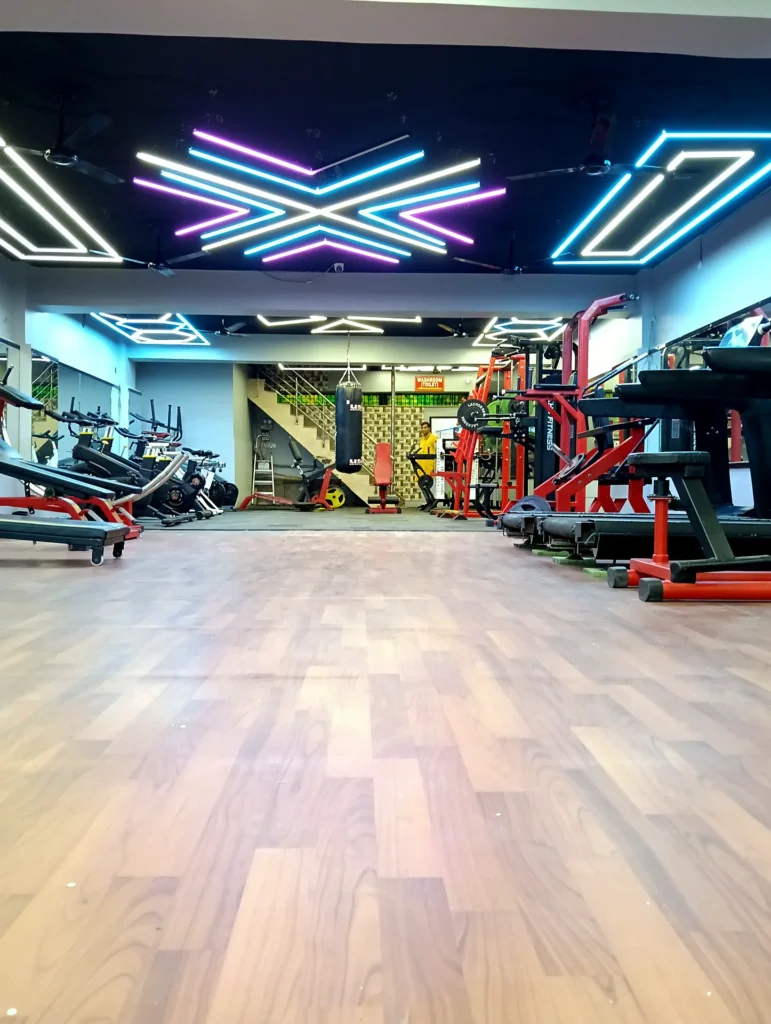 Open training space with cardio and strength machines at Arya Fitness gym